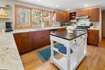 Large kitchen windows showcase beautiful views of the backyard